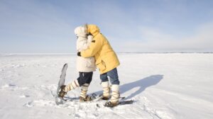 Two snowshoers kiss on the frozen snow on Great Slave Lake in Canada's Arctic. |