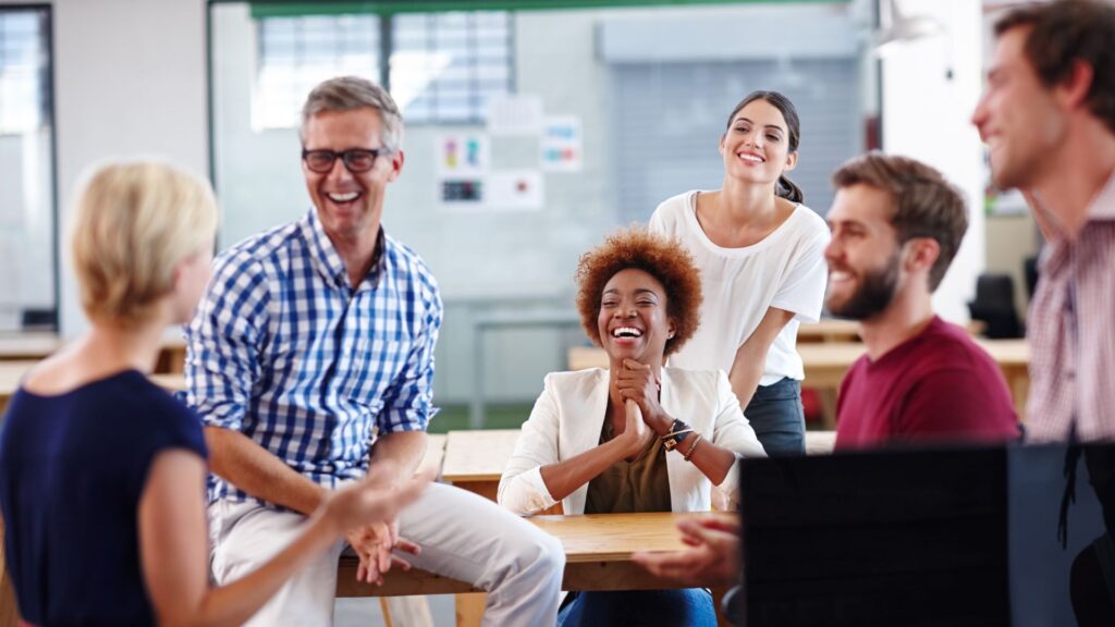 A diverse group of professionals having a meeting around a table in an office setting.